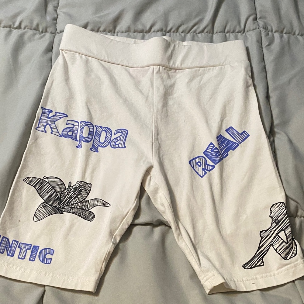 Kappa Cream Bike Shorts with Blue Graphic Text and Black Sketches
